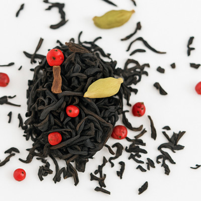 Black tea leaves with red berries and cardamom pods