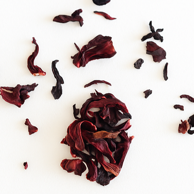 Dried hibiscus flowers arranged on a white background