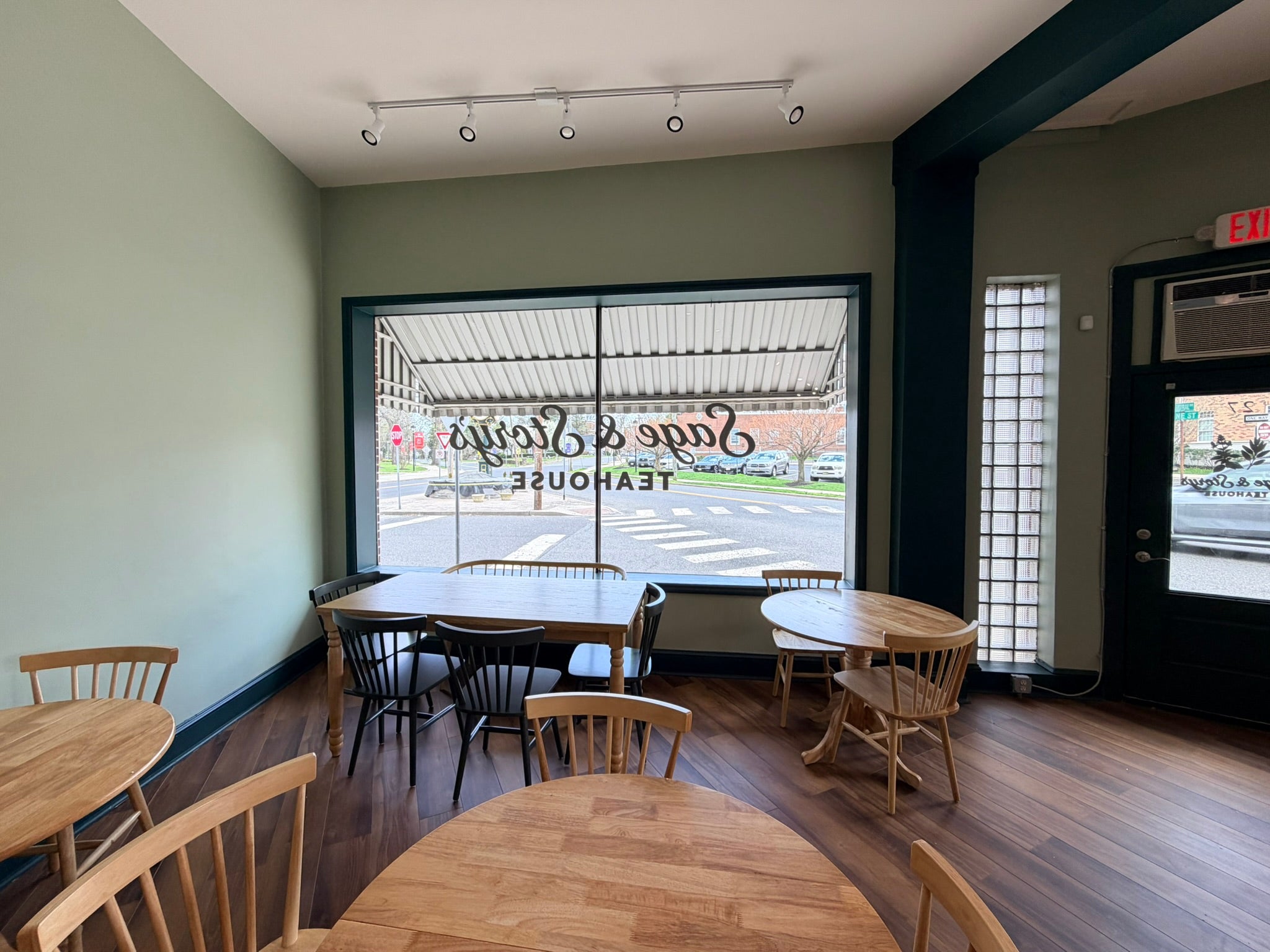 The reading-room interior at Sage & Story's Teahouse — vintage teacups and soft seating